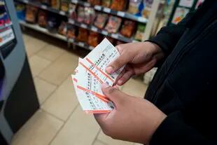 James Franklin, de Baltimore, sostiene sus boletos de la lotería Powerball que adquirió en una tienda de comestibles, el miércoles 2 de noviembre de 2022, en Cockeysville, Maryland. (AP Foto/Julio Cortez)