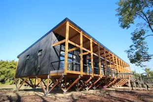 Passive houses in the Tigre Delta, Argentina, raised on pillars to allow repeated flooding of the river