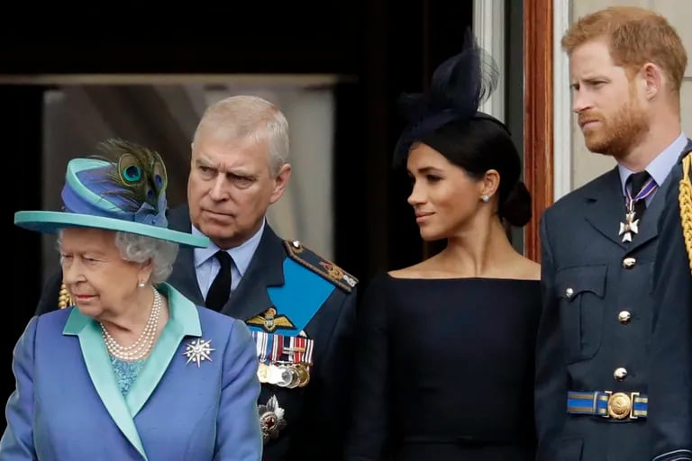 La reina Isabel II de Gran Bretaña, el príncipe Andrés, Meghan la duquesa de Sussex y el príncipe Harry se paran en un balcón para ver un avión de la Royal Air Force pasar sobre el Palacio de Buckingham en Londres, el 10 de julio de 2018
