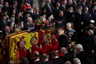 Queen Isabel II's coffin is carried by eight soldiers while King Carlos III and Queen Consort Camila follow her funeral in Westminster Abbey in central London on Monday, September 19, 2022. 