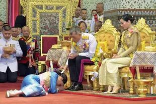 Bowing during the 2019 Maha (Rama X) coronation ceremony at the Grand Palace.  The parties, which lasted three days, cost about $31 million.  Those who greeted the heir of Rama IX, who ruled for seventy years, had to crawl so as not to ever be above his height. 