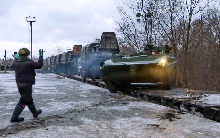 The video, taken from a video distributed by the Russian Defense Ministry's press office, shows Russian armored vehicles passing through a railway platform as they arrive in Belarus on January 19, 2022.  (Press Office of the Ministry of Defense from Russia via AP)