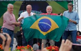 Luiz Lula da Silva y su compañero de fórmula, Geraldo Alckmin, junto al exalcalde de San Pablo Fernando Haddad, en un acto de campaña en San Pablo. (Caio GUATELLI / AFP)