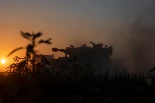 A truck carries an Israeli artillery unit to a position in the Israeli Gaza border, Thursday, May 13, 2021. (AP Photo/Ariel Schalit)