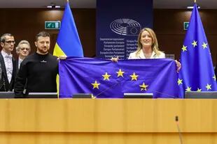 La presidenta del Parlamento europueo, Roberta Metsola y el presidente de Ucrania, Volodymyr Zelensky sujetando la bandera de la Unión Europea en Bruselas. (Alain Rolland/European Parliament/DPA) 