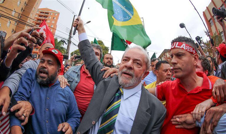 Lula llegó ayer a los tribunales de Curitiba con una bandera en la mano y rodeado de sus partidarios