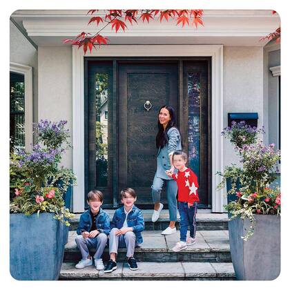 Jessica en la puerta de su casa de Toronto con su hija Ivy (6), junto a los gemelos Brian y John (9).