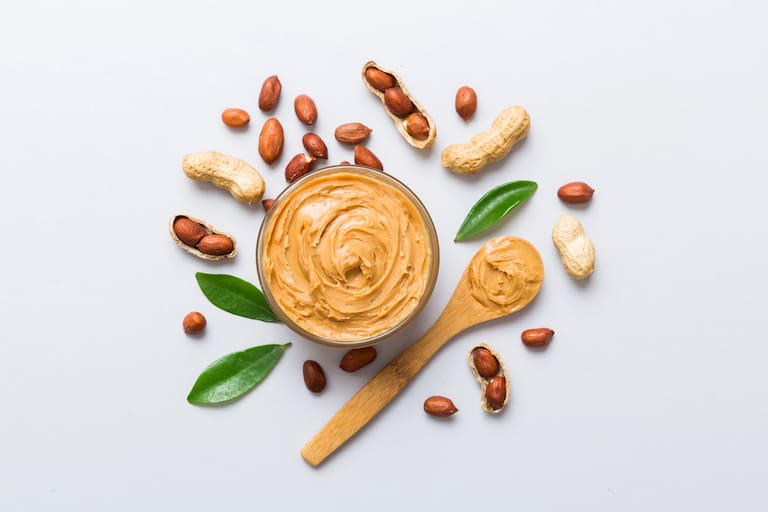 Bowl,Of,Peanut,Butter,And,Peanuts,On,Table,Background.,Top