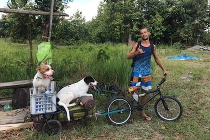 Michael Graef en su bicicleta, junto a sus dos perros, en el carro que improvisó para llevarlos siempre con él