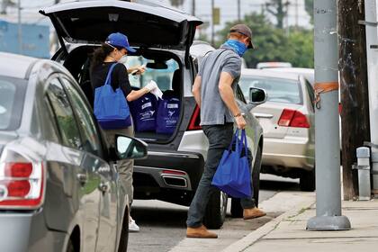 Vestidos de manera informal y resguardados con máscaras, les entregaron platos a familias de bajos recursos y a personas con enfermedades graves