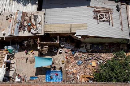 1 de febrero, 2018 – Los vecinos se refrescan en un día de calor al lado de los escombros de una casa demolida. Varias familias rehúsan irse del predio, argumentando que los subsidios habitacionales que ofrece el Gobierno no cubre ni una casa en la misma villa.