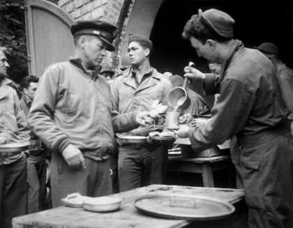 1944: el teniente coronel Bobby Jones recibe sus raciones en el campo de Normandía. 