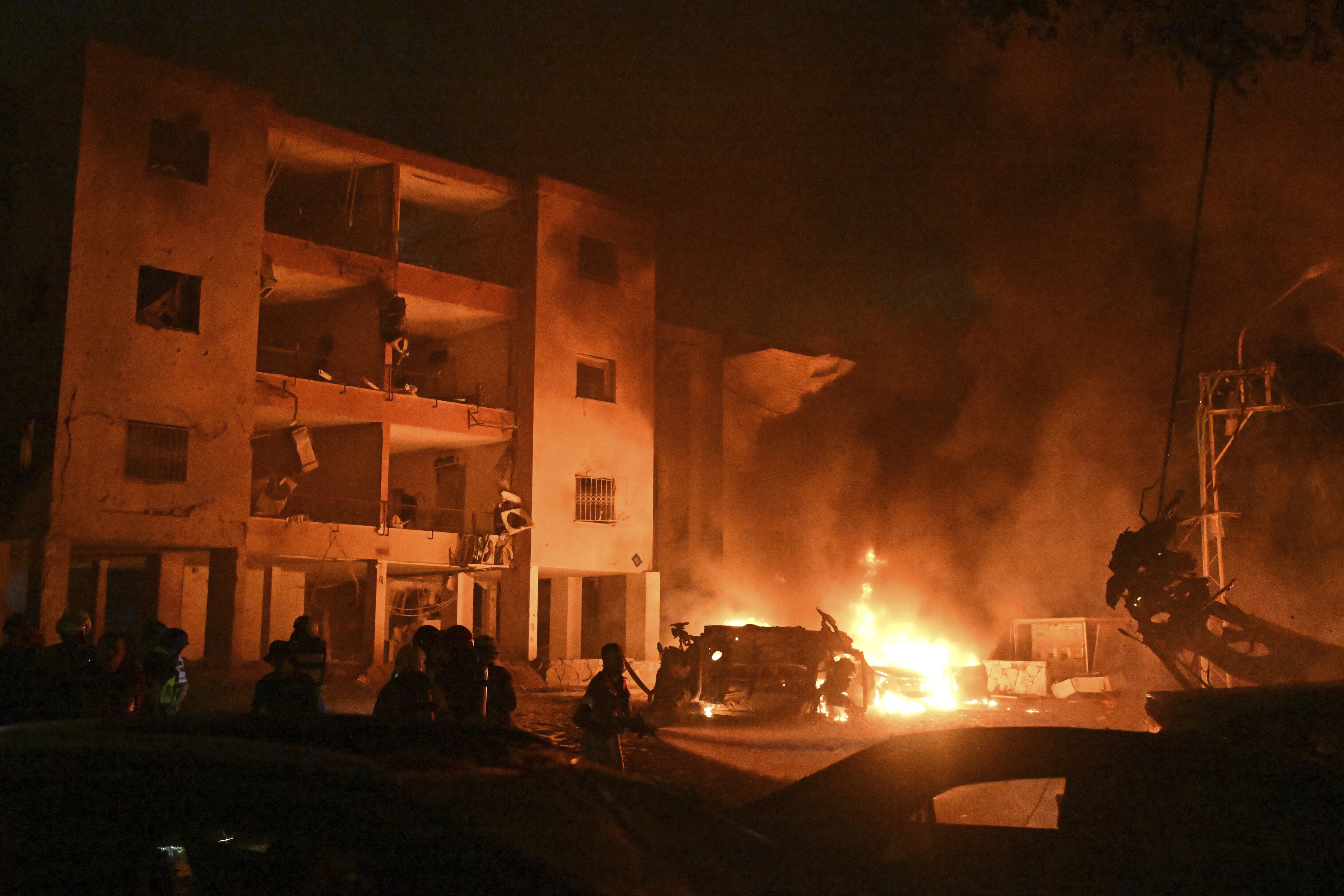 Firefighters work to extinguish a blaze after a missile launched from Iran struck Haifa, in northern Israel, on Sunday, June 15, 2025. (AP Photo/Rami Shlush)
