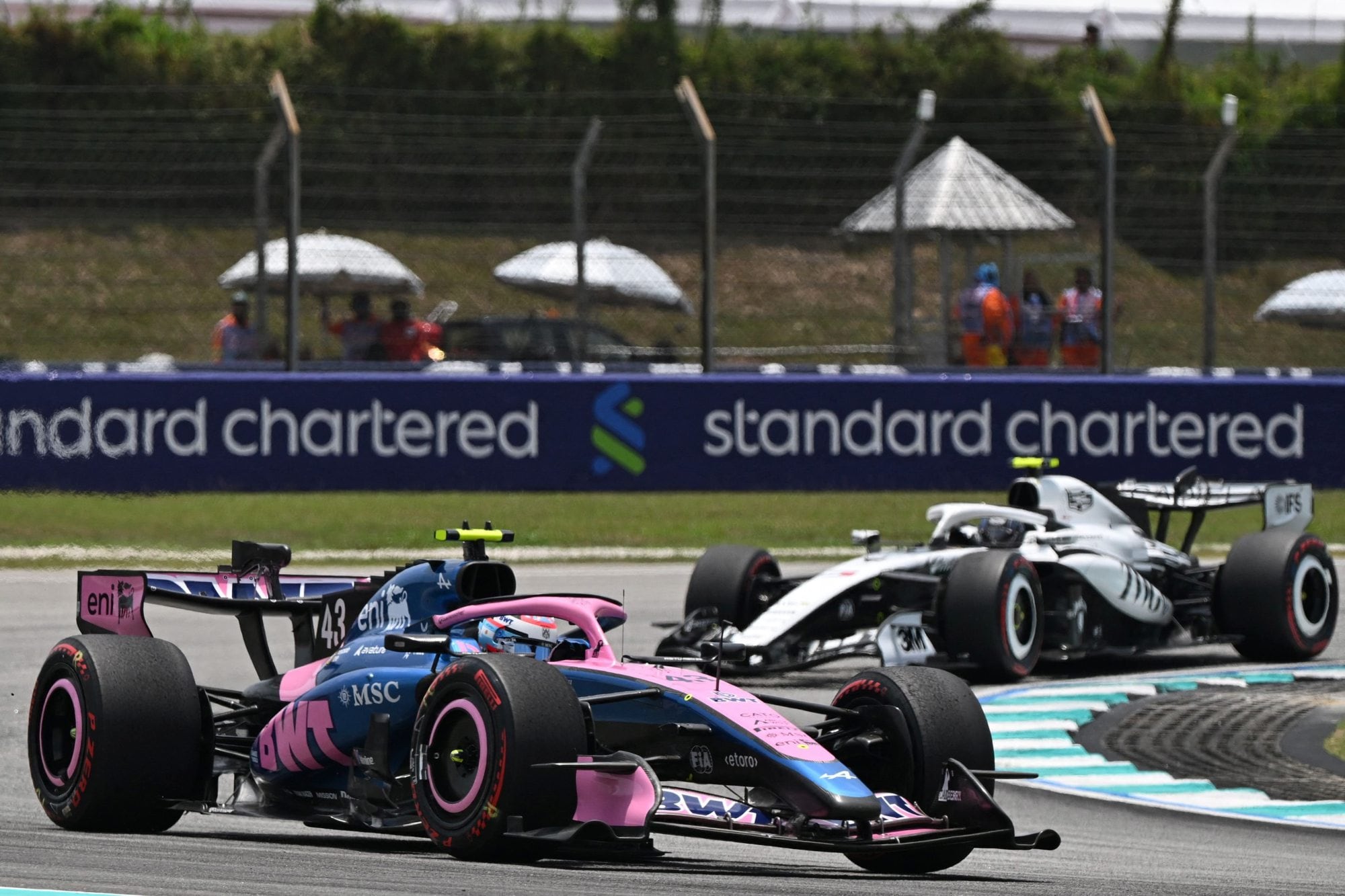 Alpine's Argentine driver Franco Colapinto (L) and Cadillac's Finnish driver Valtteri Bottas (R) steer their cars during the first practice session ahead of the Formula One Bahrain Grand Prix in Sepang on October 2, 2026. (Photo by JADE GAO / AFP)