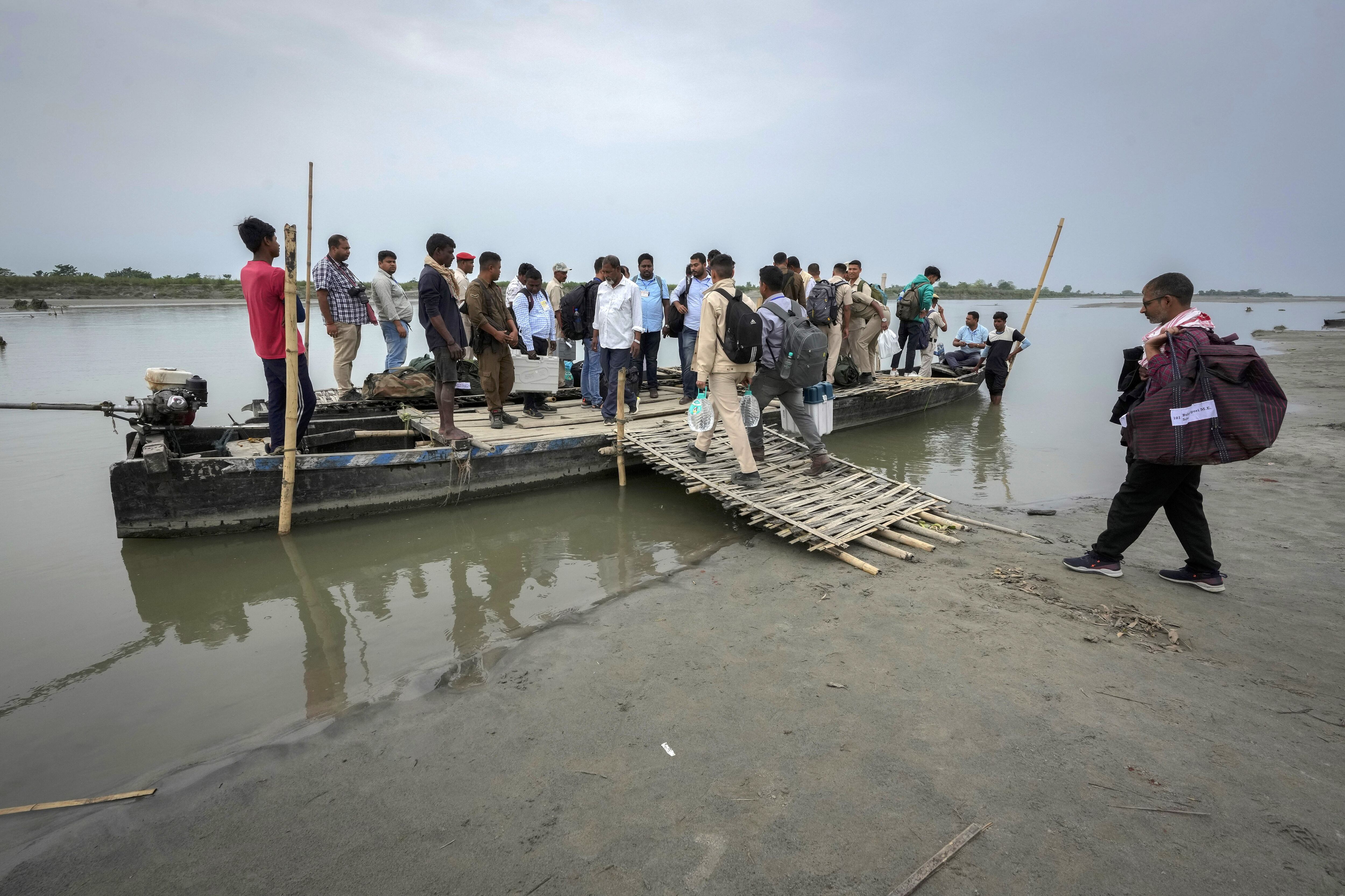 Funcionarios electorales transportan Máquinas de Votación Electrónica (EVMs) en un barco para cruzar el río Brahmaputra en vísperas de las elecciones nacionales el jueves 18 de abril de 2024.