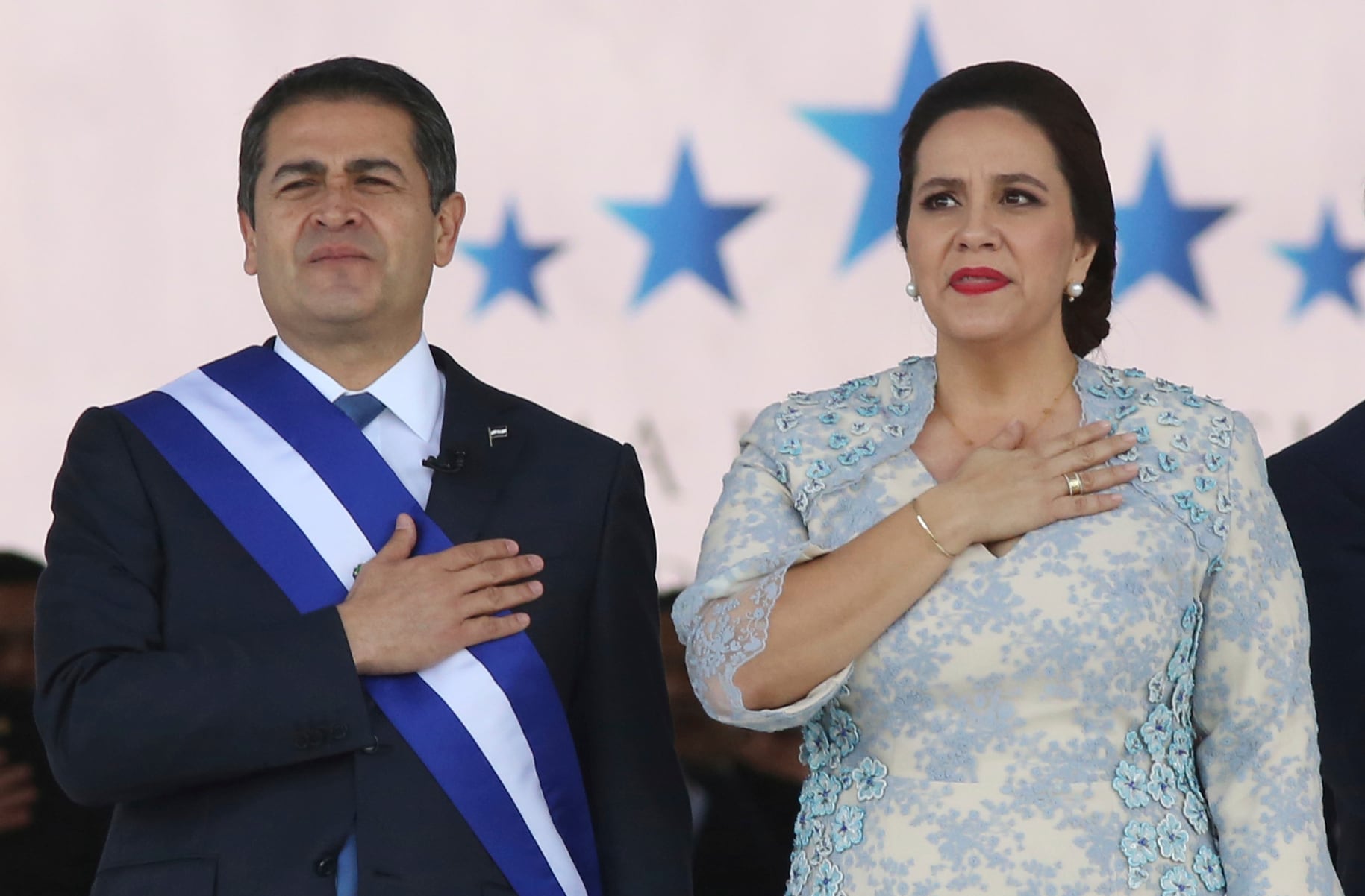 El presidente hondureño Juan Orlando Hernández de pie junto a su esposa Ana García, durante la ceremonia de juramentación para su segundo mandato en el Estadio Nacional en Tegucigalpa, Honduras, el 27 de enero de 2018.
