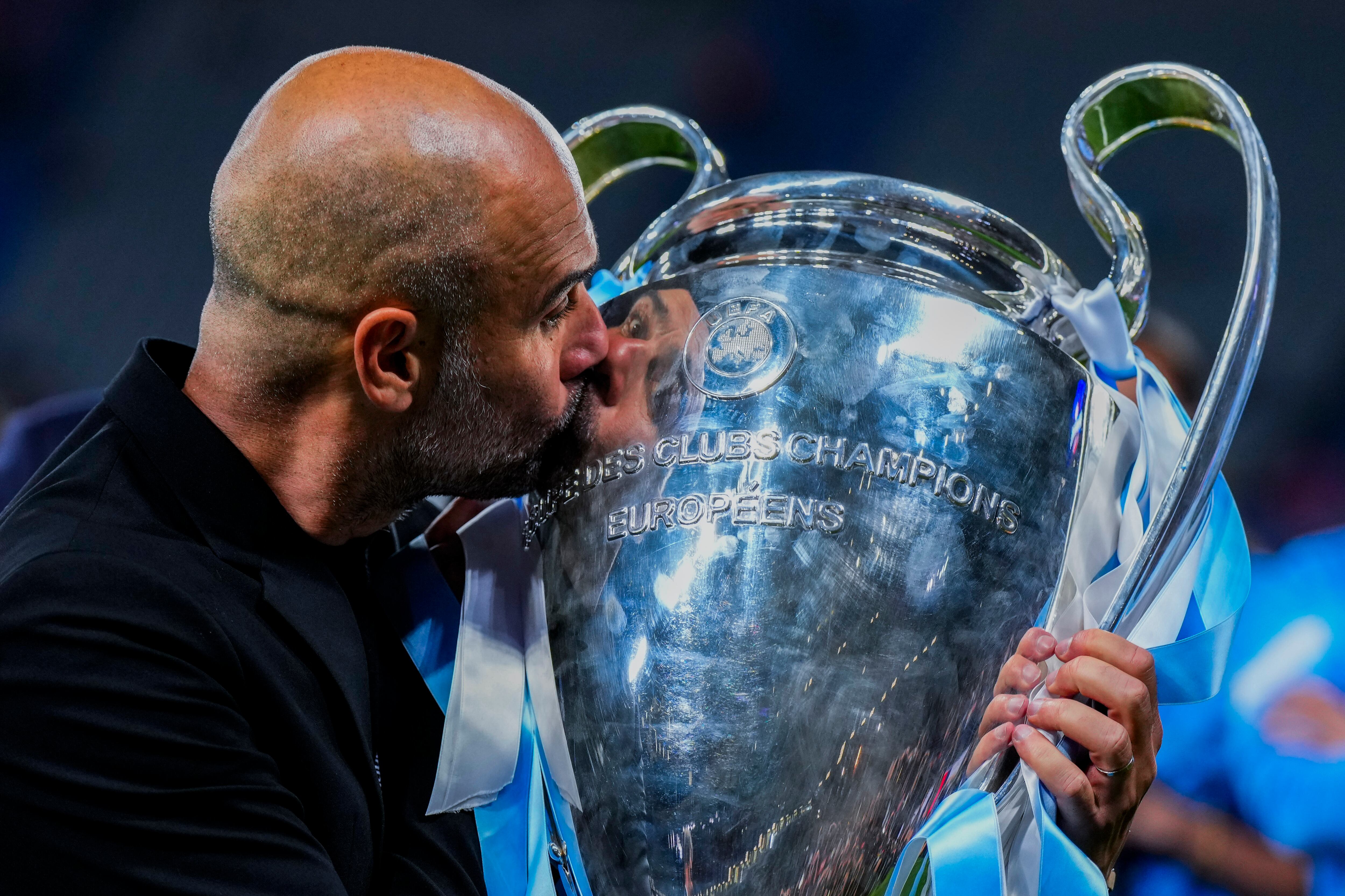 El técnico del Manchester City Pep Guardiola le da un beso a la Champions League que ganó al vencer al Inter de Milán, el 10 de junio de 2023