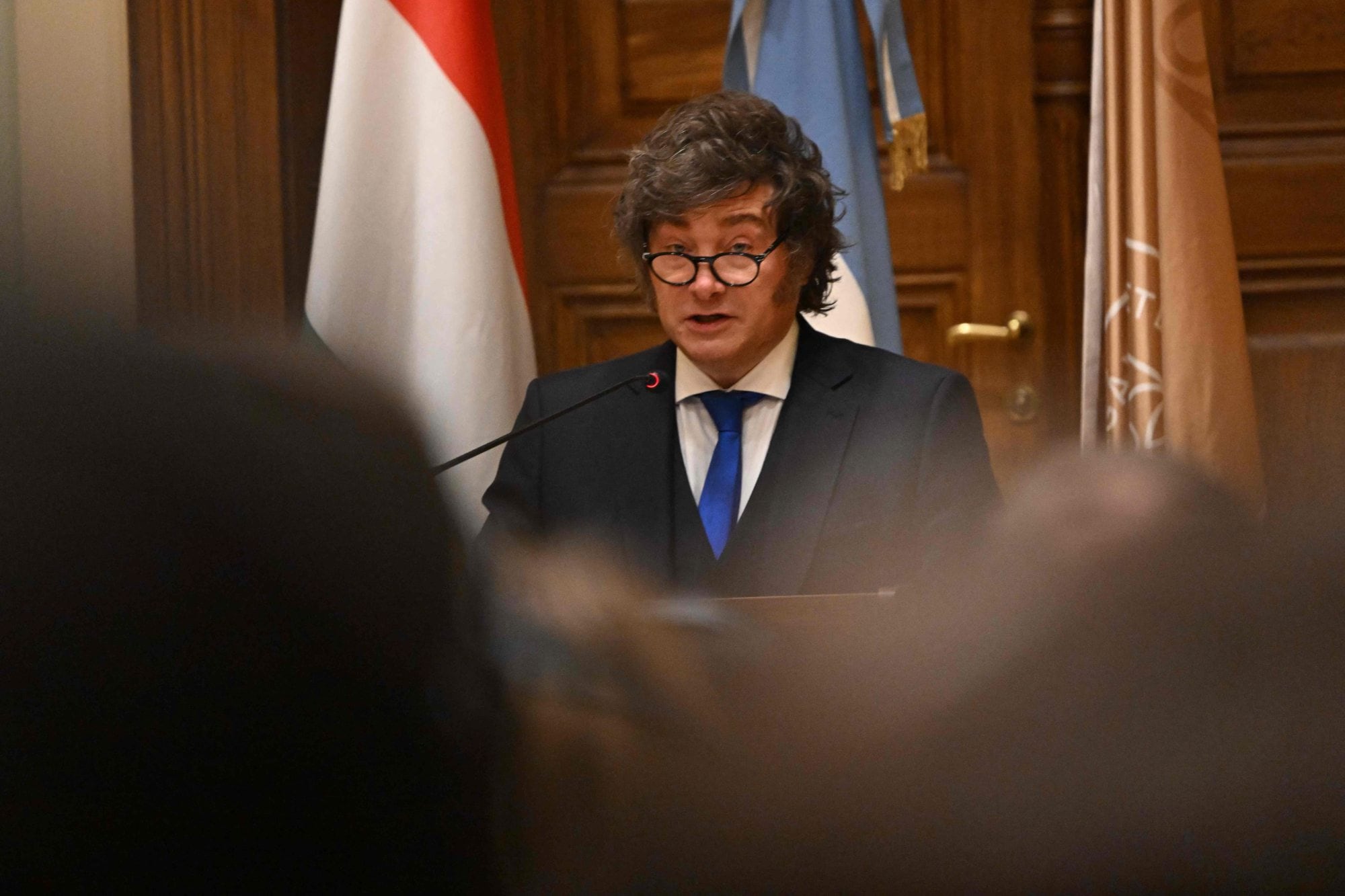 Argentina’s President Javier Milei holds the acceptance speech after receiving his honorary doctorate from the Ludovika University of Public Service in Budapest on March 21, 2026, on the sidelines of the Conservative Political Action Conference (CPAC). (Photo by Attila KISBENEDEK / AFP)