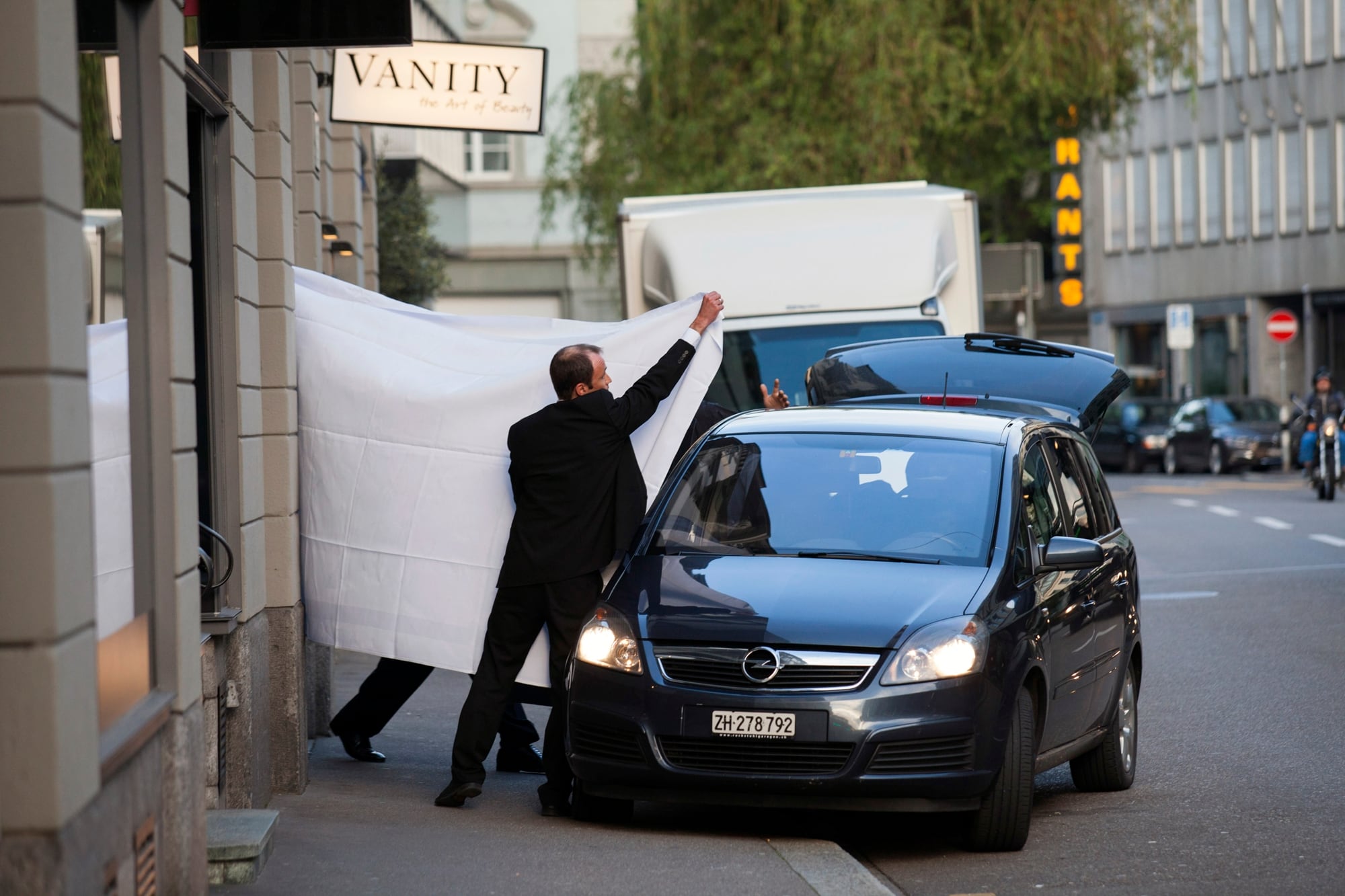 Los funcionarios de la FIFA son escoltados detrás de las sábanas luego de ser arrestados por las autoridades suizas en el hotel Baur au Lac en Zurich el miércoles 27 de mayo de 2015, el día que comenzó el escándalo de corrupción conocido como FIFAgate