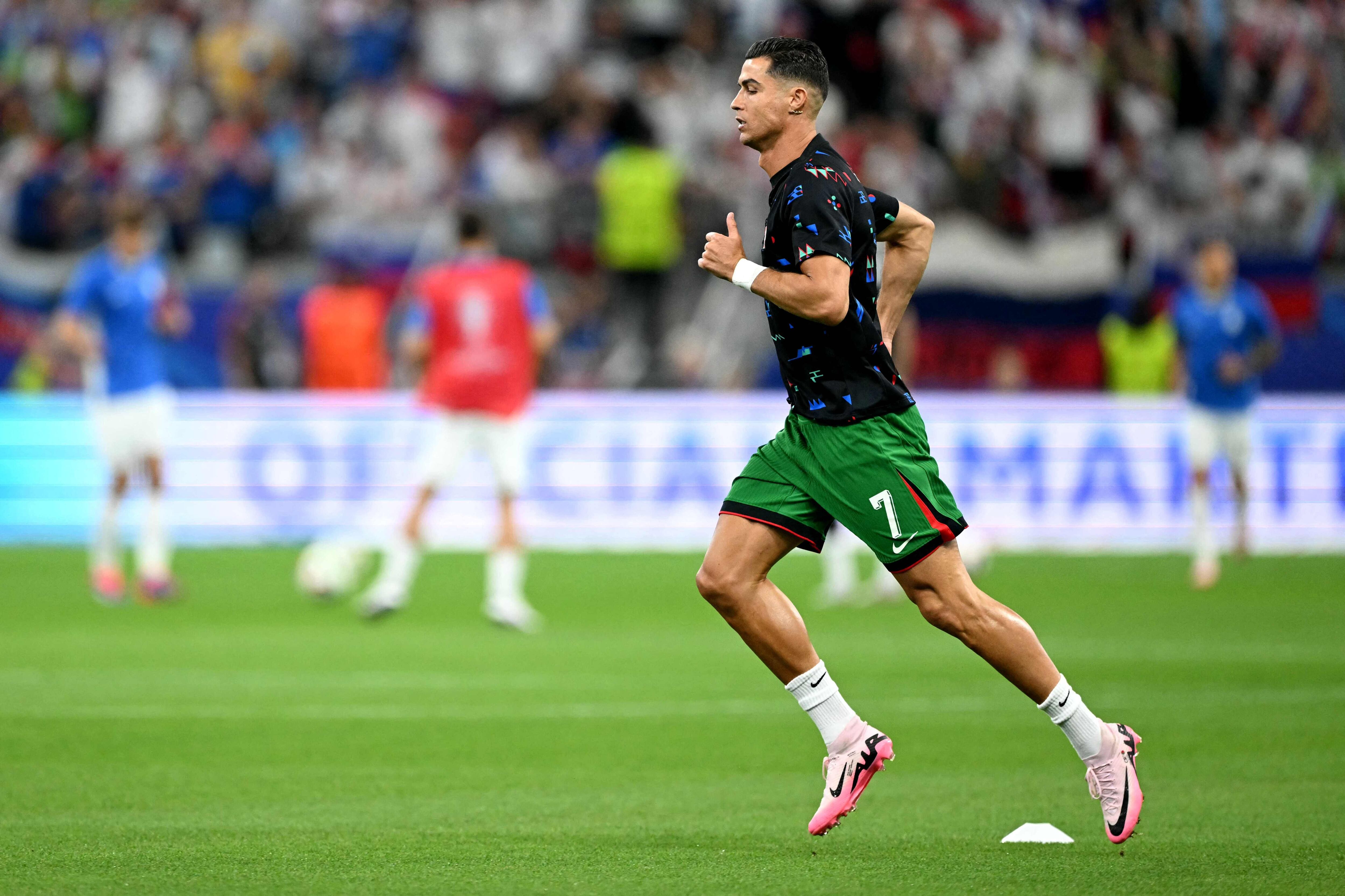 Portugal's forward #07 Cristiano Ronaldo warms up ahead of the UEFA Euro 2024 round of 16 football match between Portugal and Slovenia at the Frankfurt Arena in Frankfurt am Main on July 1, 2024. (Photo by PATRICIA DE MELO MOREIRA / AFP)
