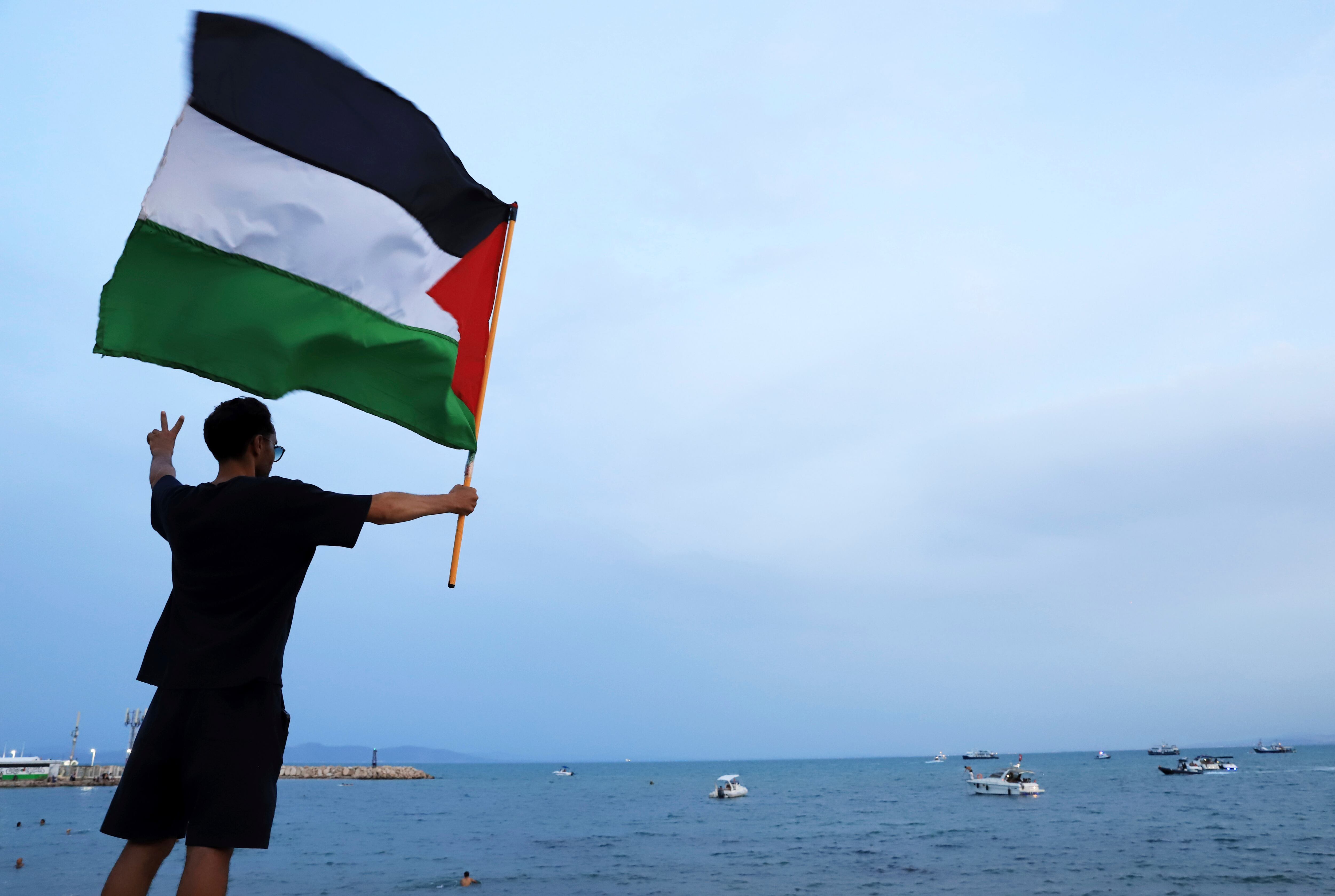 Un manifestante ondea una bandera palestina en apoyo de la Flotilla Global Sumud a su llegada al puerto de Sidi Bou Saïd, en Túnez, Túnez, el domingo 7 de septiembre de 2025
