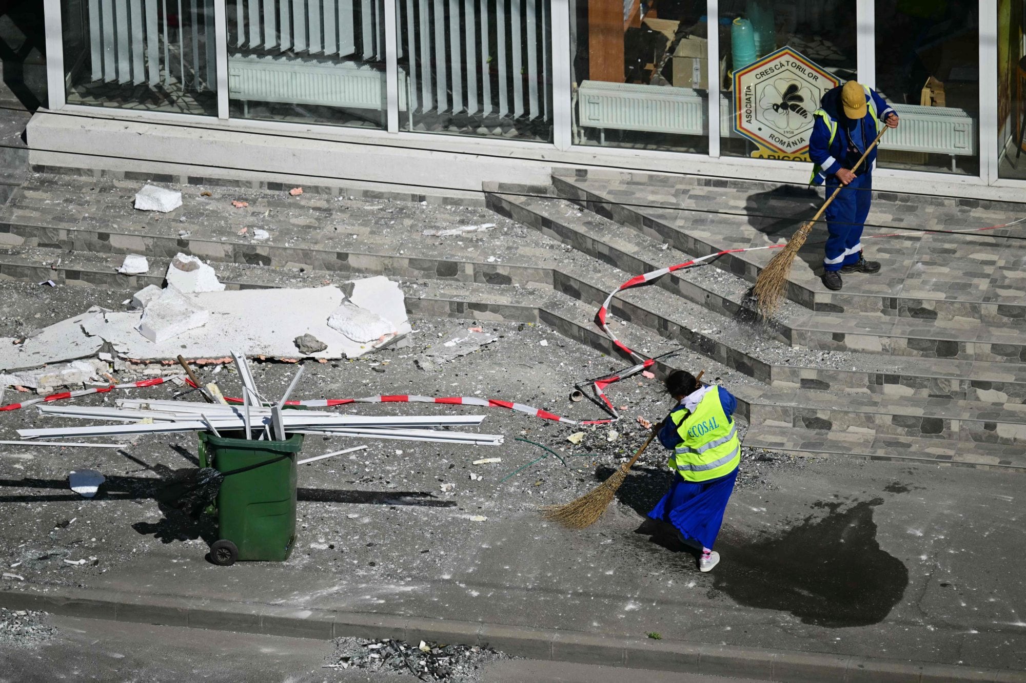 Trabajadores despejan los escombros que quedaron tras el impacto de un dron
(Daniel MIHAILESCU / AFP)