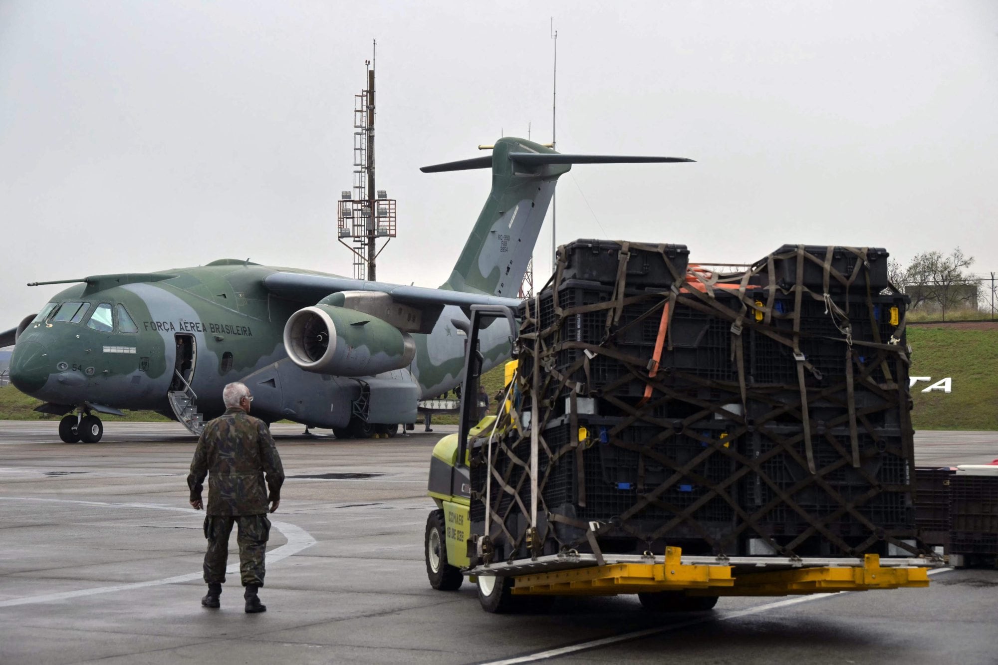 A Brazilian military man checks the loading of equipment to a Brazilian Air Force plane for a humanitarian aid mission to Venezuela following deadly earthquakes, at Guarulhos air base in Guarulhos, Sao Paulo state, Brazil, on July 26 2026. Desperate Venezuelans raced to find and rescue loved ones trapped alive beneath the rubble of collapsed buildings after two major earthquakes, measured at magnitudes 7.2 and 7.5, hit northern Venezuela killing -up to now- 589 people and leaving more than 1,500 injured. (Photo by NELSON ALMEIDA / AFP)