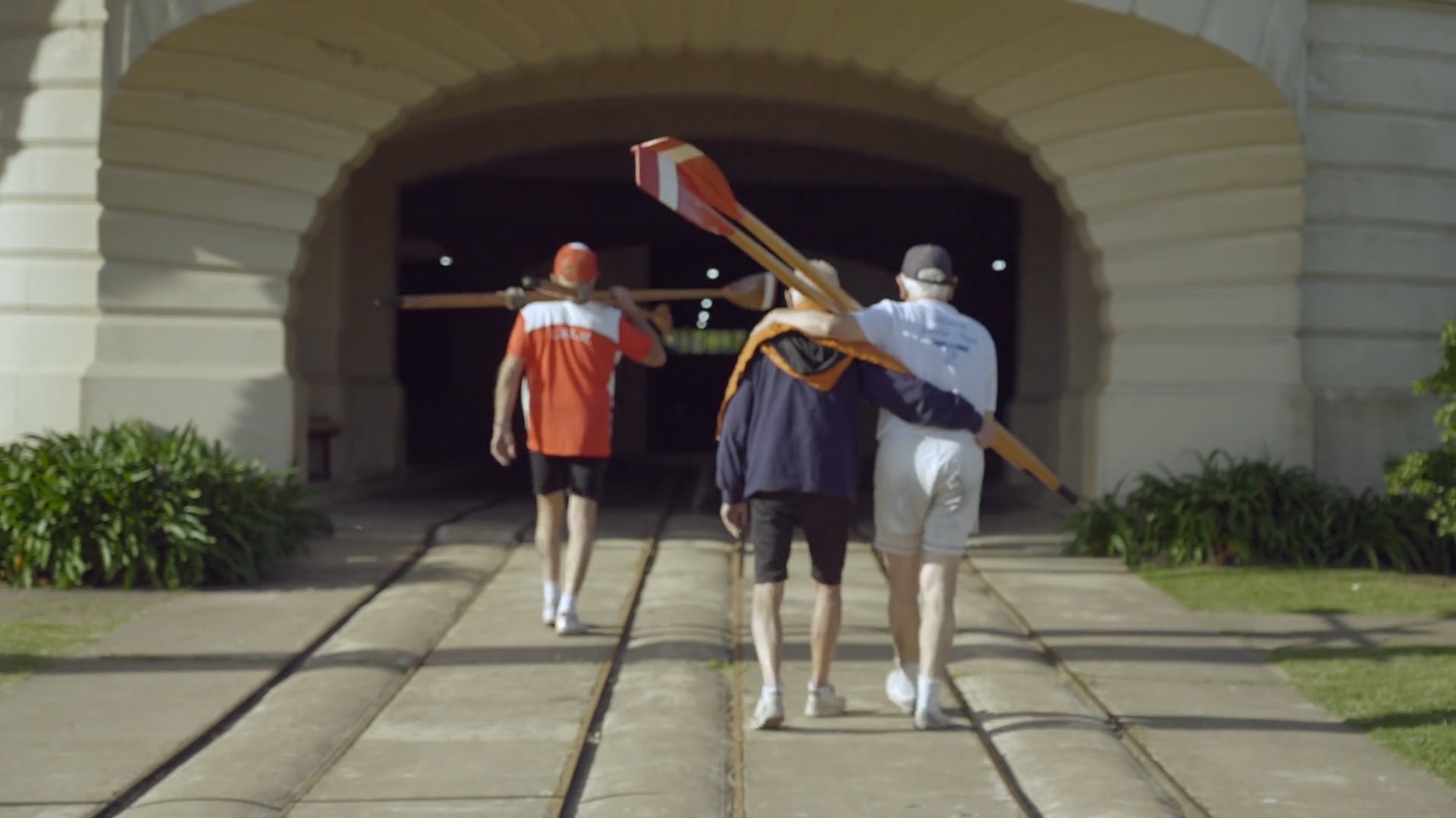 Tres amigos octogenarios cruzan el arco de entrada del club, abrazados por décadas de historias compartidas: regatas, fiestas, tardes de frío y de verano, y sobre todo, la pasión diaria por remar