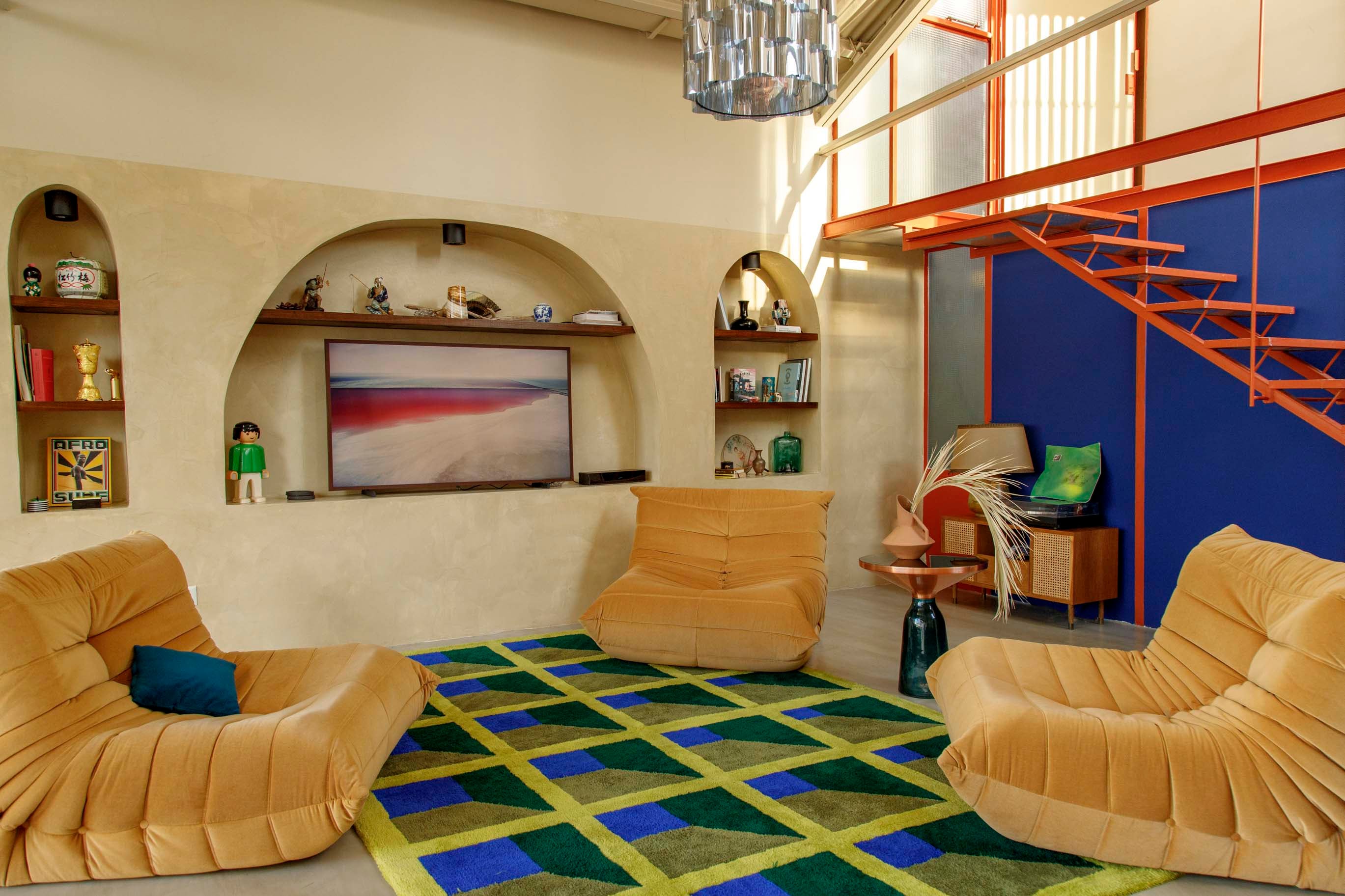 Alfombra diseñada por Eme Carranza Studio y tejida por Mooody Rugs. Sillones ‘Togo’ (Landmark). Mesa de arrime italiana. Lámpara colgante (Eme Carranza).