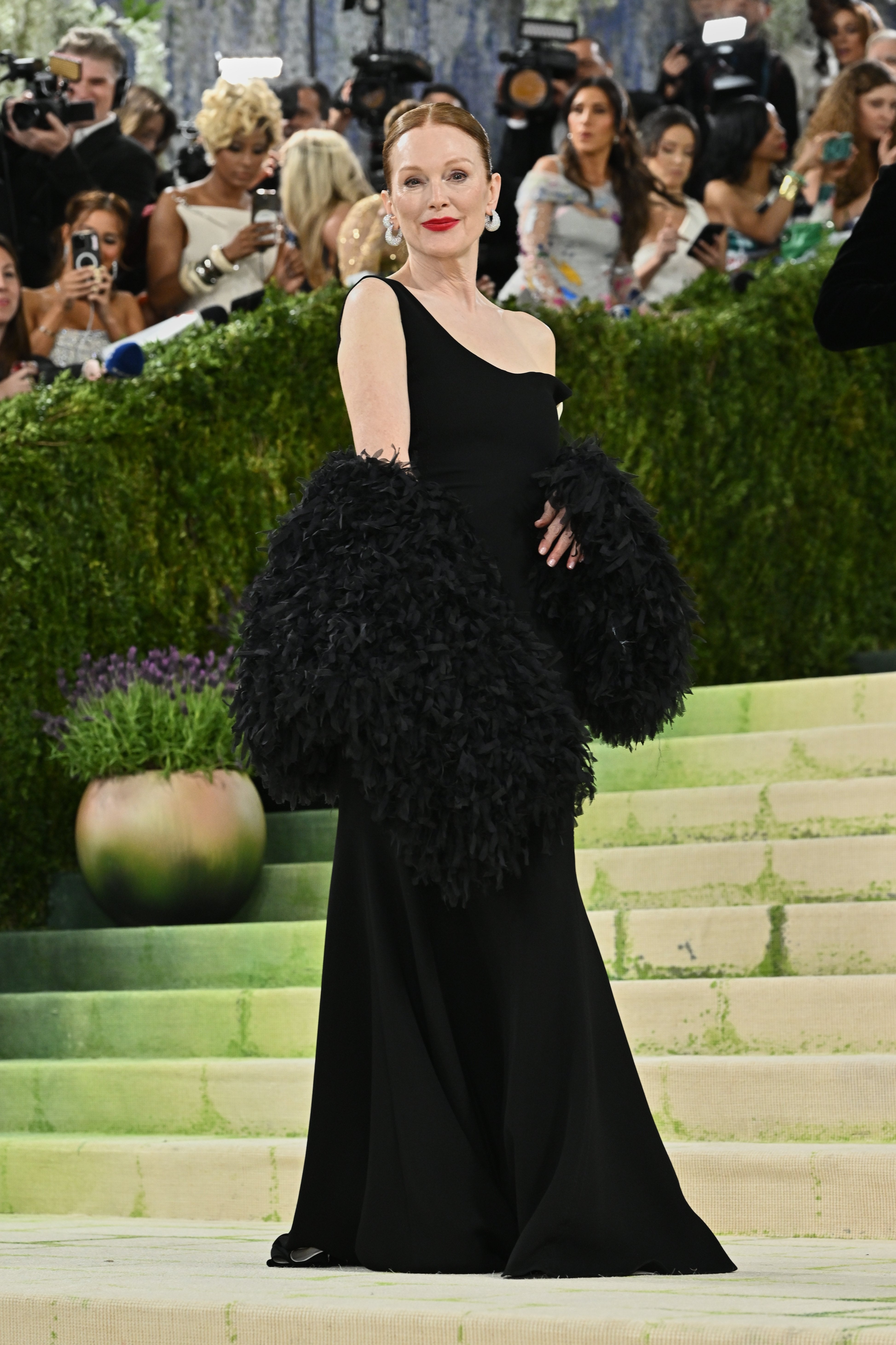 Julianne Moore optó por un vestido negro de un solo hombro y un chal de plumas