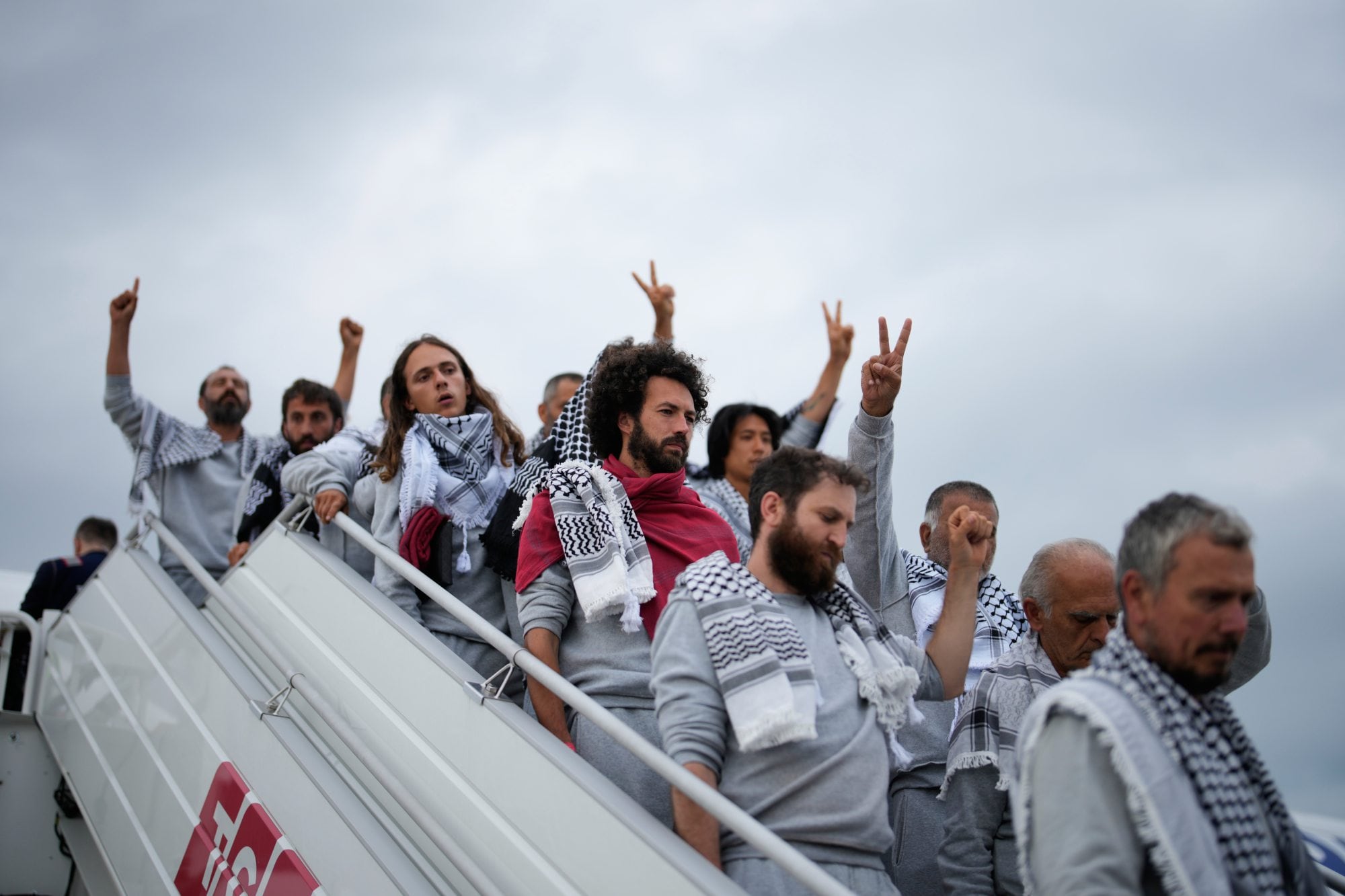 Activists from the Global Sumud Flotilla disembark a plane upon arriving at Istanbul Airport, in Istanbul, Turkey, Thursday, May 21, 2026. (AP Photo/Emrah Gurel)