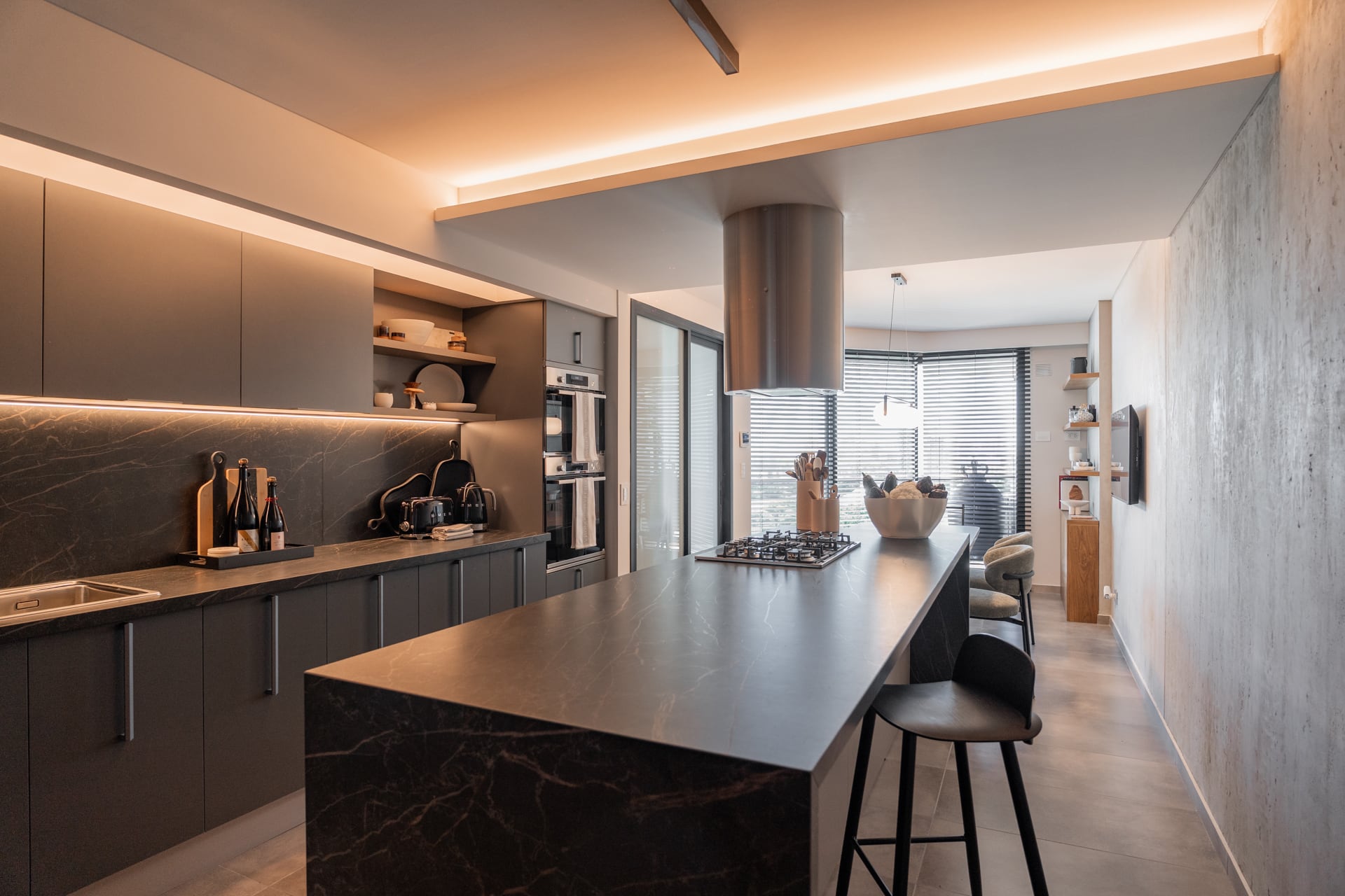 Mesada y alzada de Dekton 'Laurent', muebles en melamina 'Gris Cubanita' (Egger). Banquetas (Muro Interiorismo).