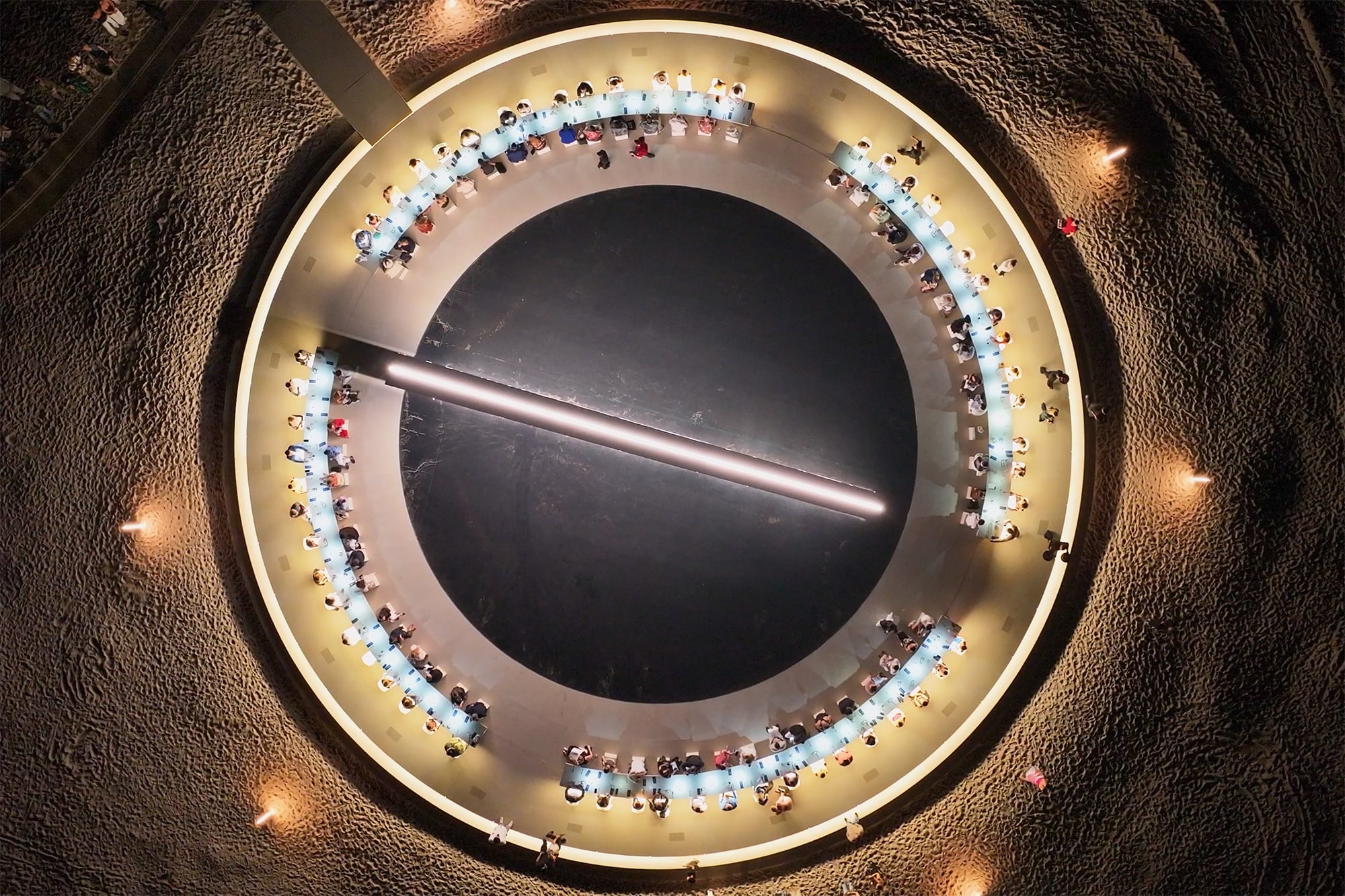 La estructura iluminada gira lentamente sobre su eje, completando una rotación cada diez minutos. Fabricada a partir de libros, acero, madera marina, espejos, agua y LED, la obra elegida por Alan Faena contiene 2.500 libros, una línea LED que despliega texto en tiempo real y una banda sonora formada por 250 fragmentos leídos por la propia Devlin, acompañados de música