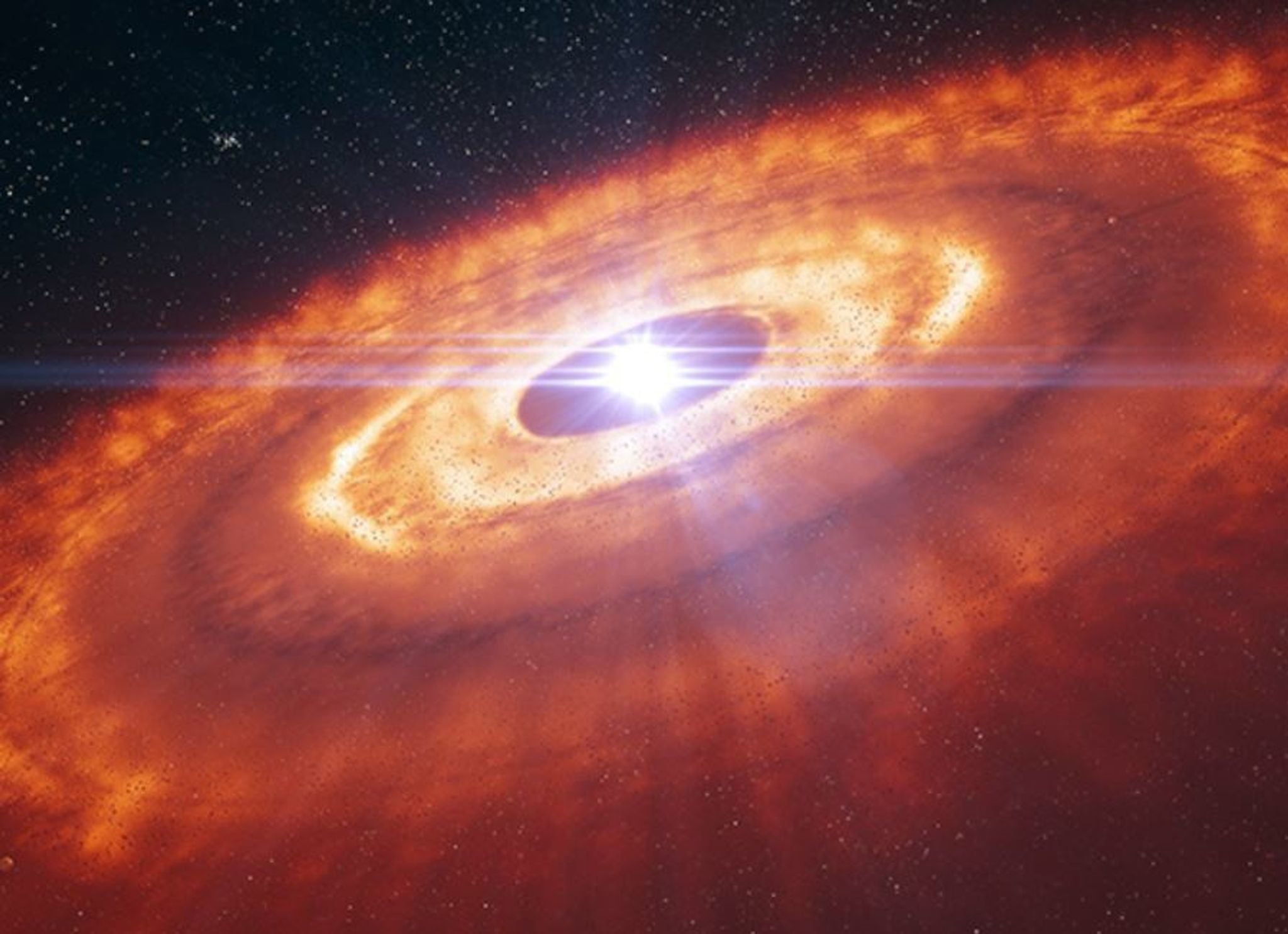 La impresión de este artista muestra una estrella joven rodeada por un disco protoplanetario, donde los granos de polvo se juntan para formar planetesimales, los componentes básicos de nuevos planetas