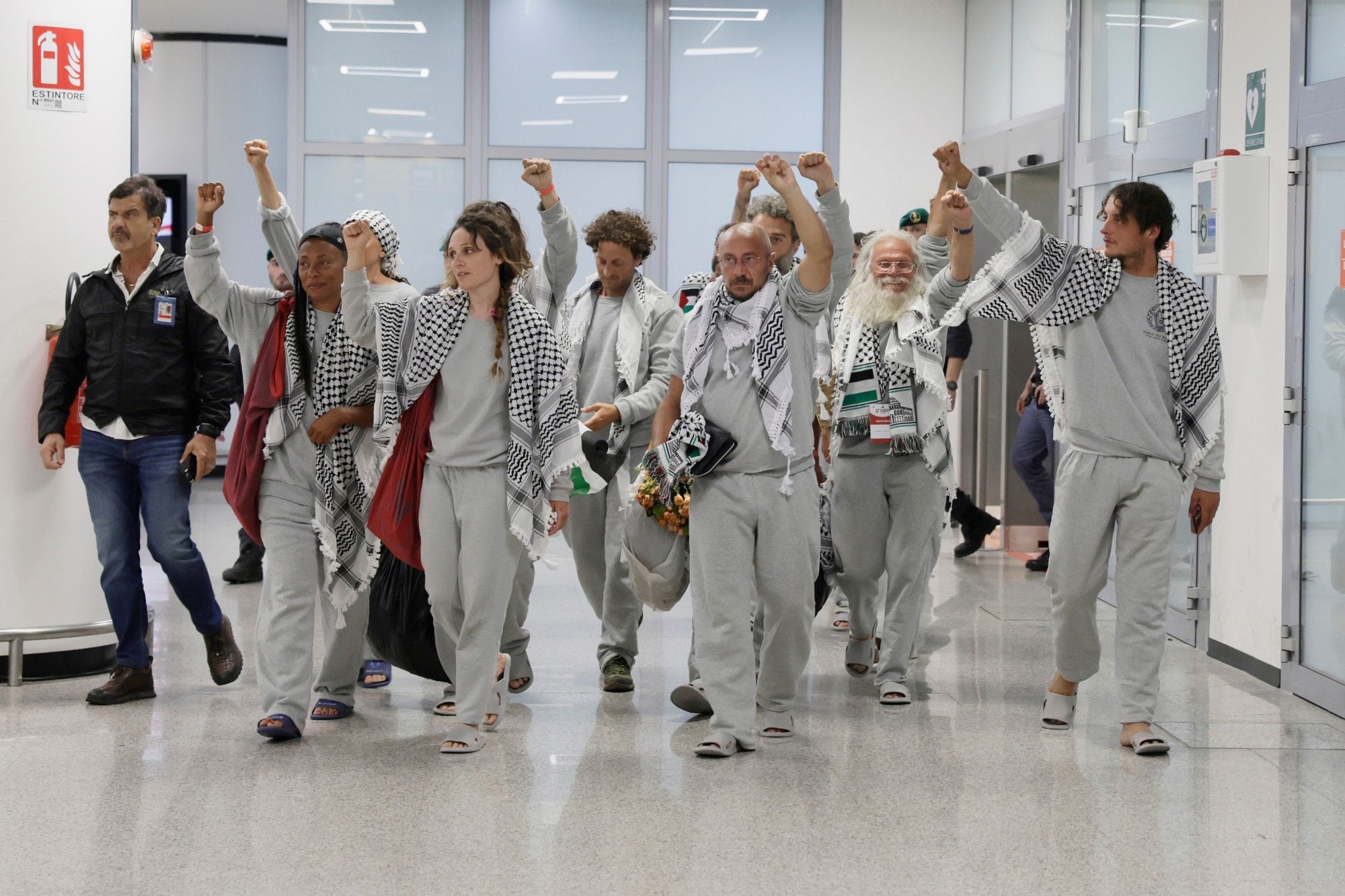 Italian members of the Global Sumud Flotilla arrive at the Fiumicino Airport in Rome on Thursday, May 21, 2026, after they were released and deported by the Israeli government after attempting to reach Gaza. (Cecilia Fabiano/LaPresse via AP)