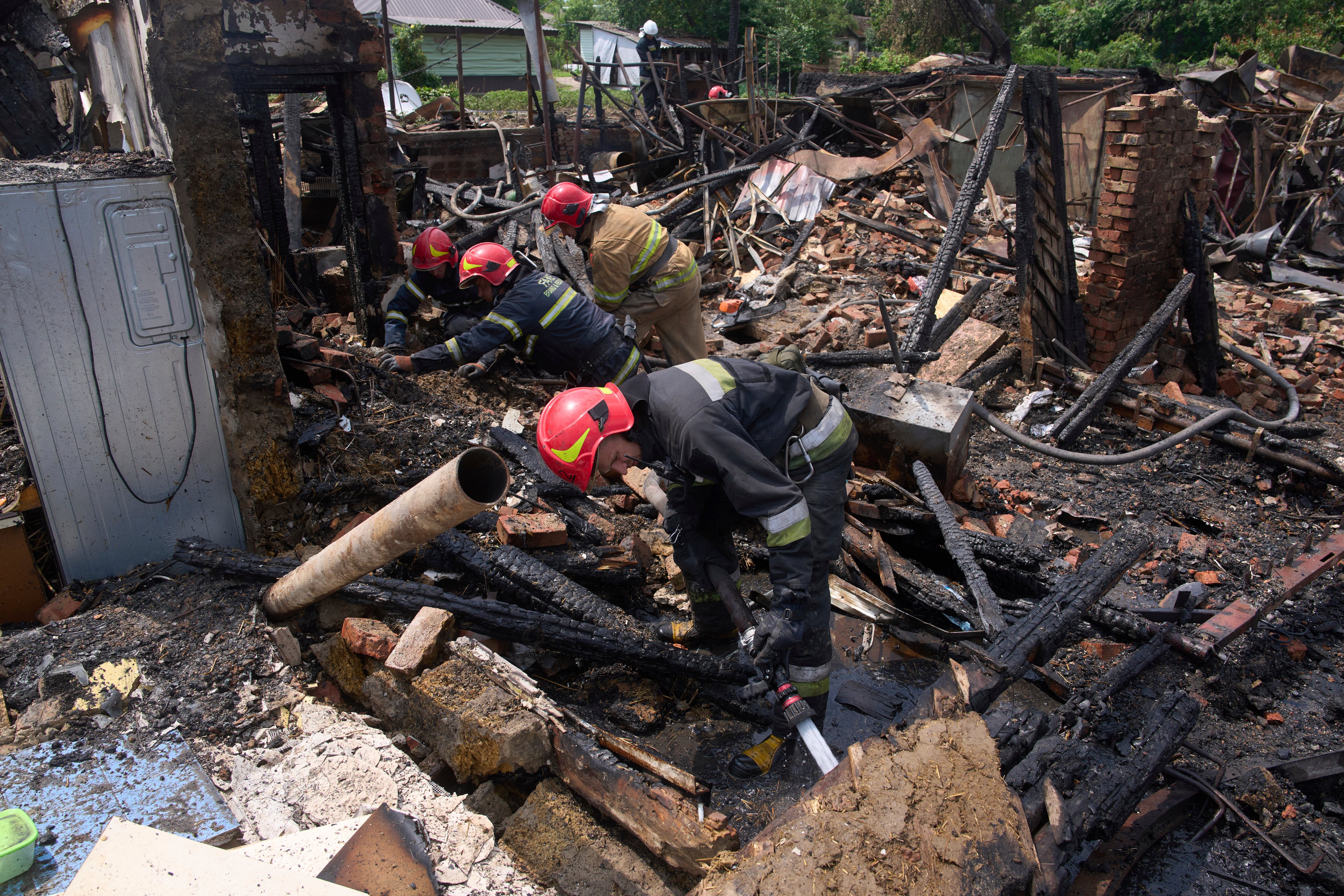 Rescatistas apagan un incendio en una vivienda destruida por un ataque ruso con drones, el jueves 5 de junio en el poblado de Pryluky, Ucrania. (AP Foto/Evgeniy Maloletka)