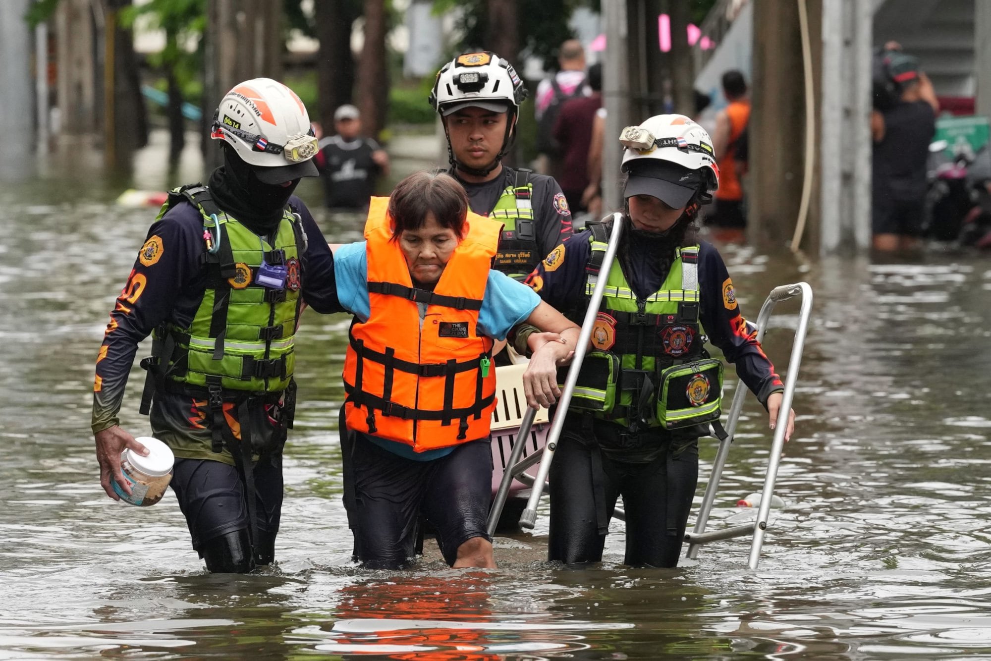 Rescuers evacuate a patient from a flooded area to a safer place after heavy rain in Bangkok, Thailand, Sunday, Sept. 27, 2026. (AP Photo/Sakchai Lalit)
