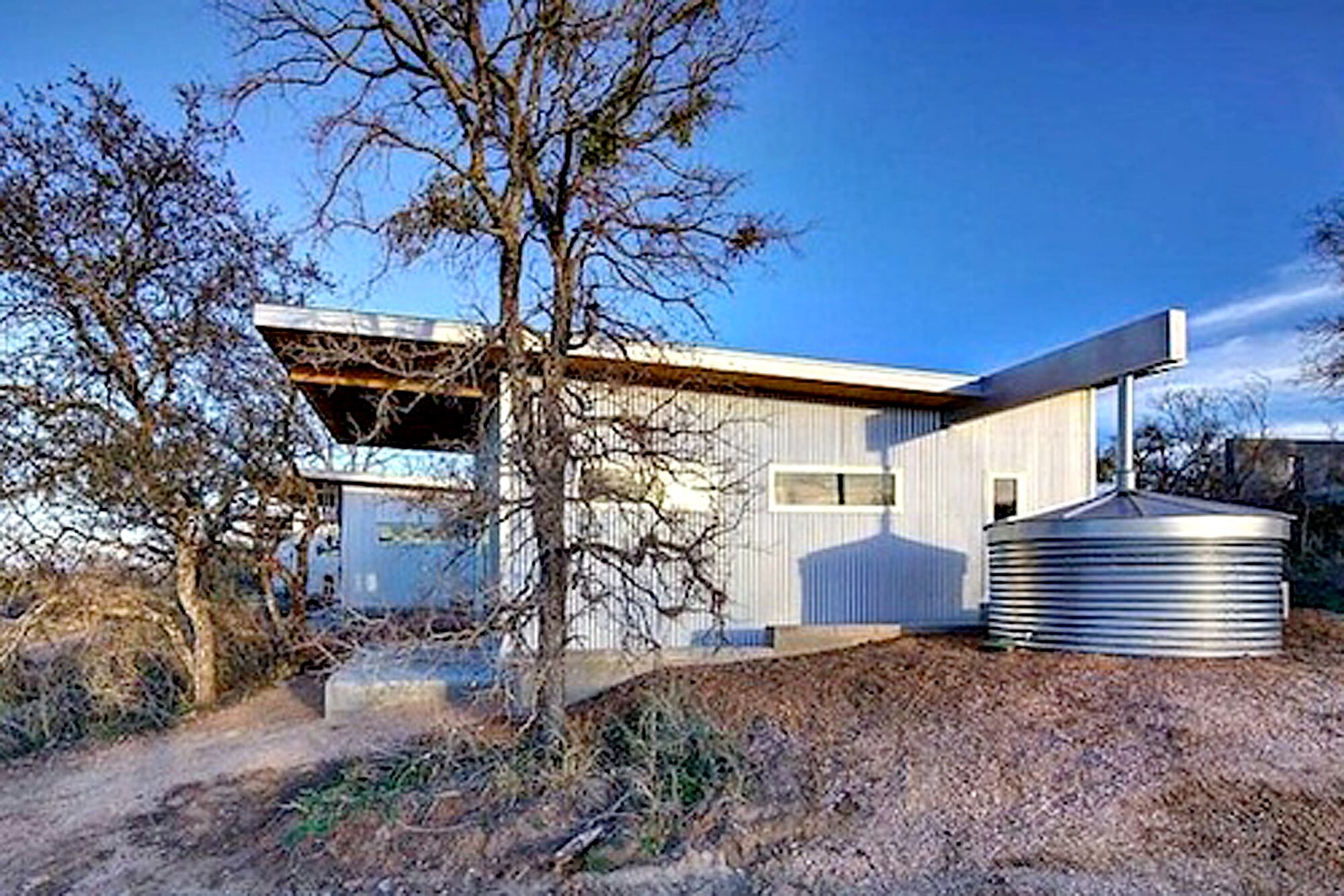 Las cubiertas en forma de mariposa canalizan el agua hacia tanques de almacenamiento con capacidad de hasta 20.000 litros, utilizados para el riego y el mantenimiento del predio