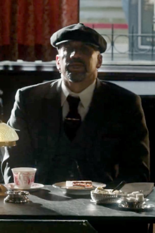 Verón sentado tomando un café durante la publicidad de la película de los Peaky Blinders