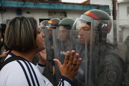 A demonstrator confronts a member of the Bolivarian National Guard in Urena, Venezuela, near the border with Colombia, Saturday, Feb. 23, 2019. Venezuelas National Guard fired tear gas on residents clearing a barricaded border bridge between Venezuela and Colombia on Saturday, heightening tensions o