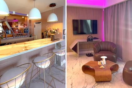 A la izquierda, la barra del departamento gamer: mesada con banquetas metálicas doradas y estantería de bebidas. A la derecha, la zona de juego en modo nocturno: LED perimetral magenta, pantalla LG, volante de simulación de carreras (MEXX Gamers), butacas de cuero (Lumare), mesa baja de madera y cortinas (Darlux).