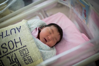 A nurse examines new born chinese childs with their mums at the Queen Elizabeth Hospital on 30 April 2012 in Hong Kong. Babies born in the Year of the Dragon are thought to bring prosperity and wisdom to their families, spurring what is forecast to be a 5-per-cent increase in the birth rate this year. By a United Nations estimate, 31 babies are born every minute in China. Photo by Victor Fraile (Photo by Victor Fraile/Corbis via Getty Images)