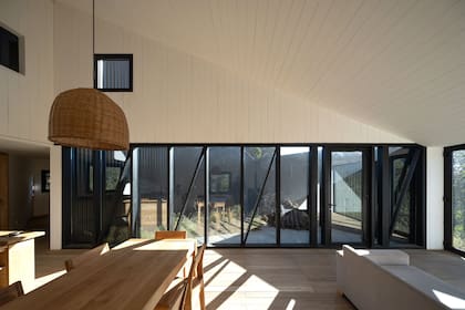 Aberturas de aluminio con doble vidriado hermético (De la Canal Vidrios, San Martín de los Andes). Lámpara colgante (La casa del mimbre, Puerto de frutos)