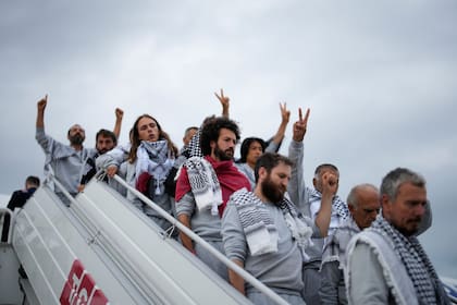Activists from the Global Sumud Flotilla disembark a plane upon arriving at Istanbul Airport, in Istanbul, Turkey, Thursday, May 21, 2026. (AP Photo/Emrah Gurel)