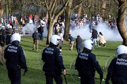 Agentes de la policía belga rodean miles de personas reunidas en el parque Bois de Cambre de Bruselas