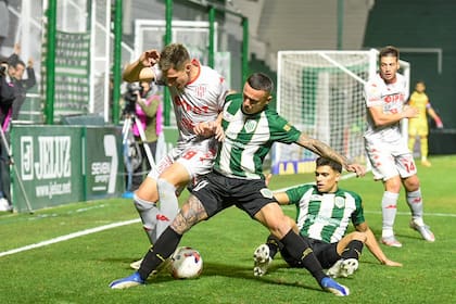 Agustín Urzi y Ramiro Enrique luchan con Juárez, autor del 2-1 de Unión en la cancha de Banfield