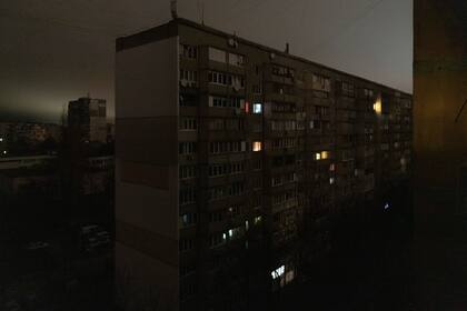 Algunas ventanas de un edificio de apartamentos se ven iluminadas durante un apagón en el centro de Kiev, Ucrania. el lunes 14 de noviembre de 2022