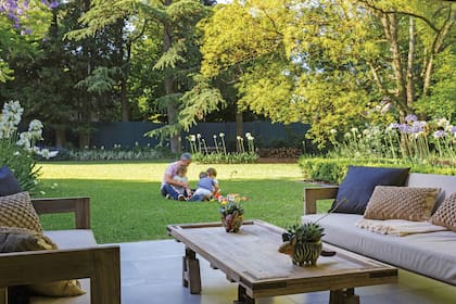 Almohadones de yute tejidos en macramé (Vero Alessandrini). Manta con flecos (Huitrú). Sobre la mesa, mulitas de cerámica con cactus y suculentas (Salazar Casa).