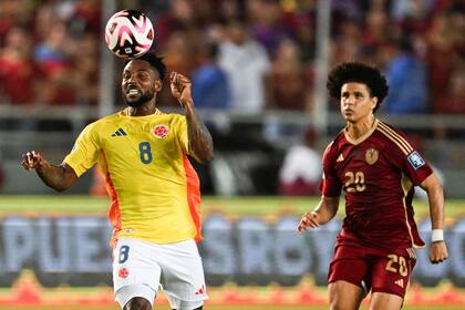 Alvaro Angulo controla la pelota ante la marca de Eduard Bello (Photo by Juan BARRETO / AFP)