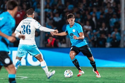 Álvaro Ocampo va a pegarle a la pelota ante una llegada de Bruno Zuculini para marcar.